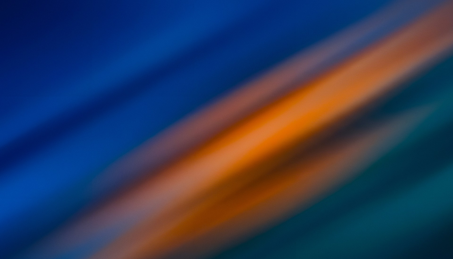 Vlexo Webdesign – Abstraktes blau-orangefarbenes Hintergrundbild